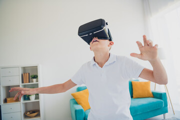 Portrait of charming little boy experience vr glasses wear t-shirt modern interior flat indoors