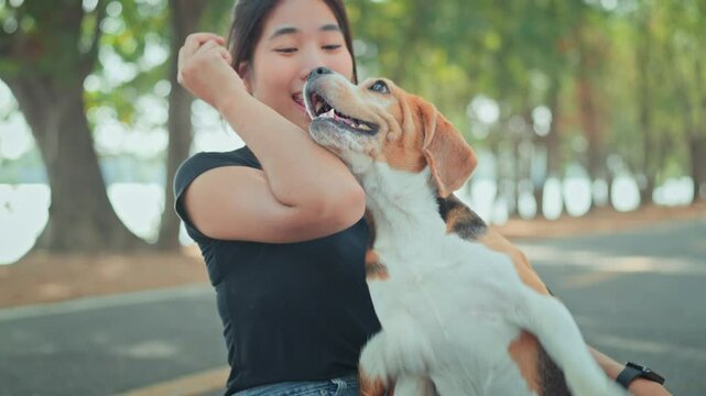 Happy asian woman playing with dog together in public park outdoors, Friendship between human and their pet