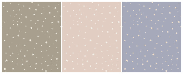 Tiny Stars Seamless Vector Patterns.Irregular Hand Drawn Simple Starry Print for Fabric,Textile,Wrapping Paper. Infantile Style Galaxy Design.Little Stars Isolated on a Green, Blue and Light Pink.