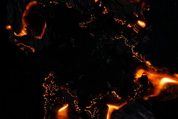 burning paper, glowing edge of paper on a black background
