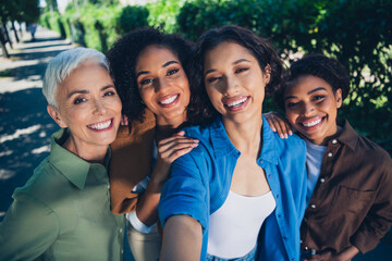 Photo portrait of happy multi generational women take selfie photo having fun together multiracial friends outdoor city park