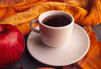 White cup of coffee on background with autumn elements and colors