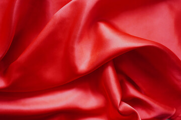 Texture red satin or silk is beautiful and luxurious (blurred).