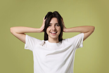 Portrait of cute teenage girl on olive background