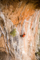 A rock climber ascends to the summit via a difficult route.