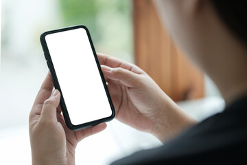 Close up shot of man holding a smartphone with a blank white screen, for mockups or showcasing mobile apps and websites.