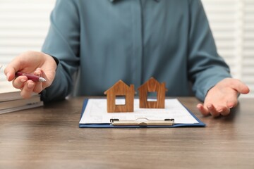 Real estate agent working at wooden table, closeup