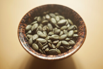 Healthy seeds - closeup of raw pumpkin seeds in a bowl, for follicular phase of menstrual cycle