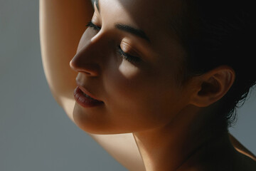 Lovely young woman with dark hair and eyes closed in sunlight