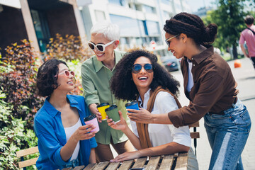 Photo of group friends women speak clink coffee cup weekend chill street cafe table outdoors