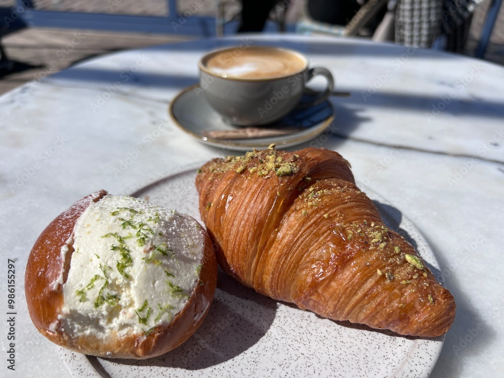 Wall mural plain croissant cut in half, showing the cross section, a classic crescent-shaped croissant. isolate