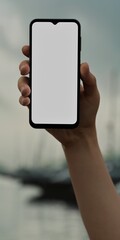 Caucasian White male using smartphone with a blank white screen. Yachts, marina, boats apps mockup. Vertical phone orientation