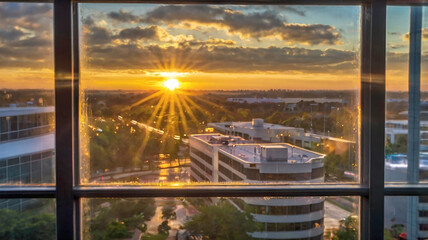 Fototapeta premium Blurred bokeh of a sunrise breaking through the window of a tech startup office