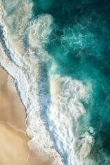 Fototapeta premium Aerial View of Turquoise Ocean Waves Crashing on Sandy Beach