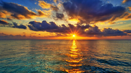 Fototapeta premium Blurred bokeh of a sunrise over a calm ocean