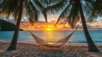 A hammock is hanging between two palm trees on a beach. The sun is setting in the background, creating a warm and relaxing atmosphere