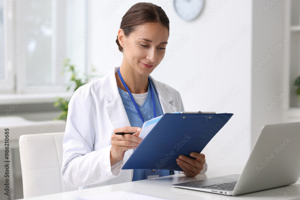 Wall mural nurse with clipboard and pen at white table in clinic