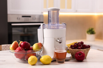 Modern juicer, fresh fruits and glass on white marble table in kitchen