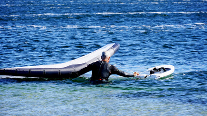 Man practices wingfoil in the Mediterranean Sea.