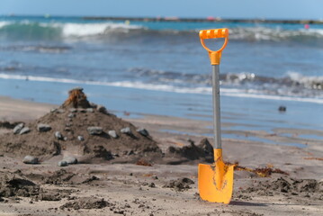 yellow shovel on the beach