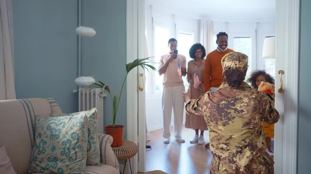 Cinematic video of a woman coming back home from the army military service in the us. Family reunited at lunch time indoor in a beautiful american house.