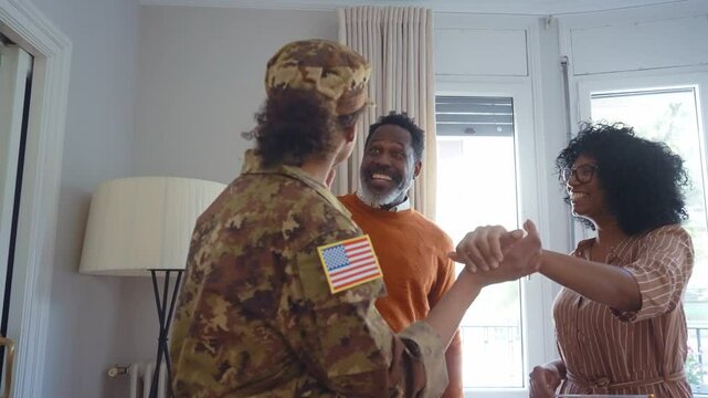 Cinematic video of a woman leaving for the military army service and greeting her father, mother and brother at home.