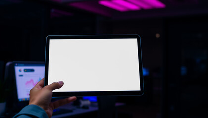 Hands holding digital tablet with blank screen indoors