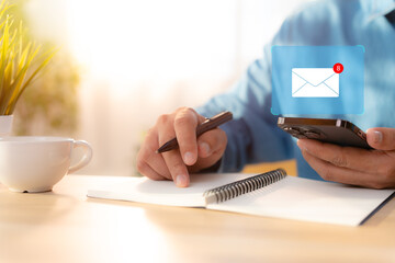 A Businessman using mobile phone open an email with sign reminder for unread emails for...