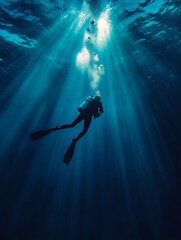 A diver explores the deep sea while sunlight filters through the water, creating a serene underwater atmosphere