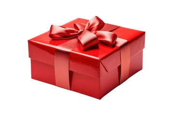 Obraz premium A beautifully wrapped gift box with a shiny red ribbon and bow, placed at a slight angle isolated on white background