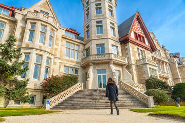 A woman walking in the Magdalena Palace in the city of Santander, Spain