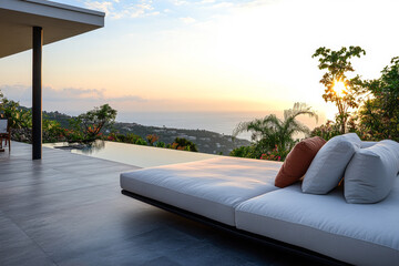 Sunset view from a tranquil hillside patio overlooking the ocean with comfortable seating and lush surroundings in a tropical setting