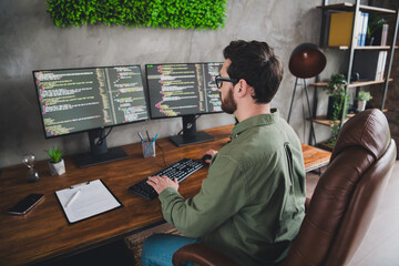 Photo of professional it specialist young man write keyboard computer desktop loft interior office...