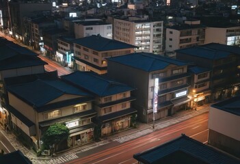 Aerial view of a city at night with a hotel sign