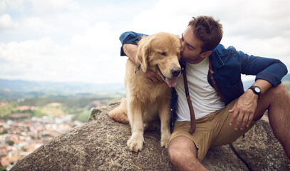 Man, kiss and dog in nature for travel, hiking and holiday with bonding, connection and portrait. Male person, love and golden retriever outdoor for pet care, vacation or break on weekend with puppy