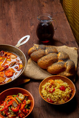 Hot cholent in a cast iron pan on the festive table for the Rosh Hashanah meal