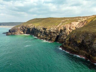 Fototapeta premium An aerial view of the coast of the atlantic ocean, St Agnes Heritage Coast in Cornwall, UK