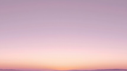 Clear sky at twilight with light pastel pink and orange tones near the horizon