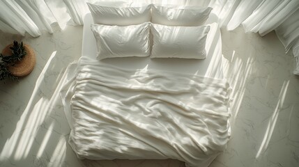 Cozy white bed with rumpled blankets and pillows in a minimalist bedroom setting