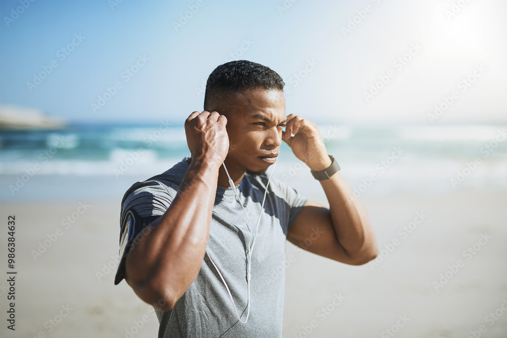 Canvas Prints Running, music and thinking with man on beach for start of training, fitness and streaming. Race, exercise and marathon cardio with runner in nature for podcast, health and sports performance