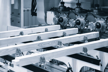 A stack of wood is being cut by a machine. Industrial concept