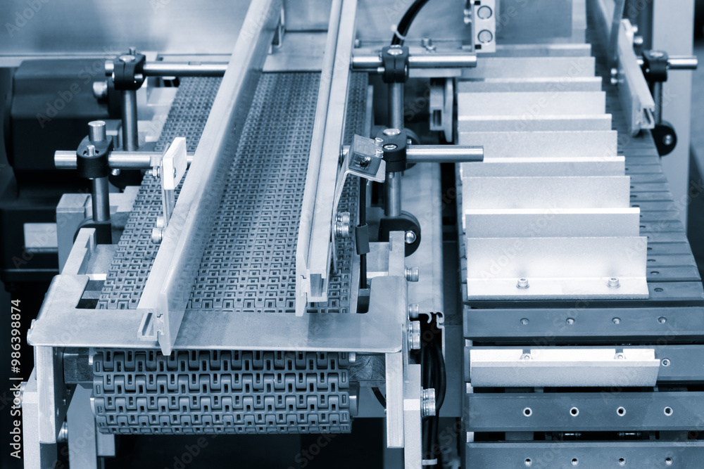 Fototapete a conveyor belt with a white and silver color is moving. the conveyor belt is made of metal and has 