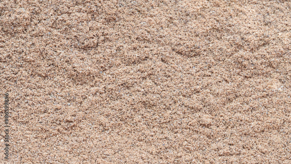 Aufkleber a sandy surface with a few small rocks scattered about. the surface is a mix of sand and dirt, and t