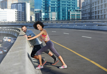 Road, portrait and couple with stretching for fitness, exercise and preparation for training challenge in city. Bridge, man and woman with body warm up for running, marathon competition and wellness