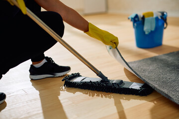 Close up of cleaning parquet floor with  mop.