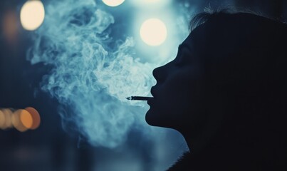 Fototapeta premium Silhouette of woman smoking in blue smoke.