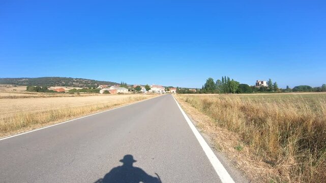 French Way of Saint James - a paved road entering Atapuerca, province of Burgos, Castile and Leon, Spain