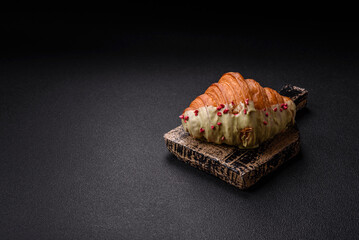 Crispy sweet red croissant with pistachio, raspberry and strawberry