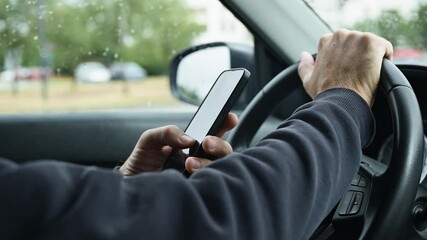 Male driver is driving car and texting on mobile phone, 4k slow motion