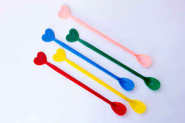 A photo of a colorful teaspoon. This spoon is used to take sugar and then stir the sugar in the hot tea.